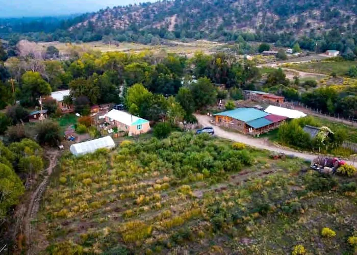 Log Casita Overlooking Pond And Waterfall Near Taos, New Mexico