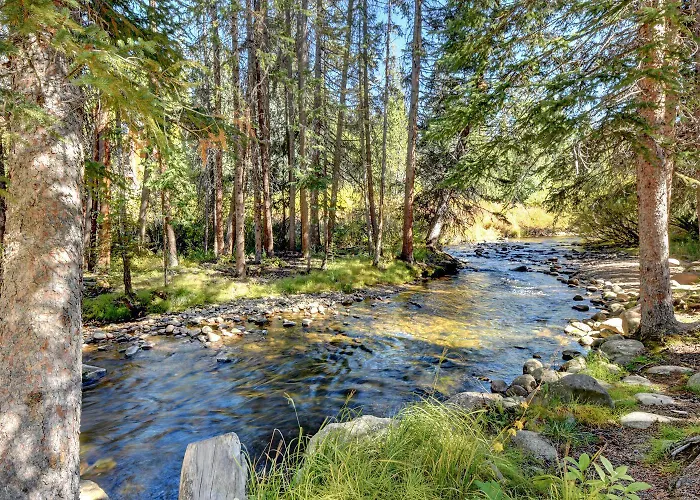 Riverfront Ski Retreat: Luxury Condo with Hot Tub & Activity Perks
