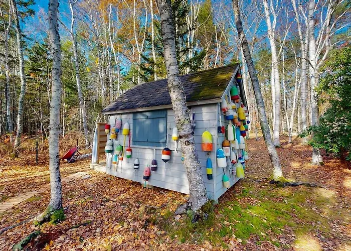 Charming Riverfront Home With Cozy Interiors, Dock, And Scenic Deck Views