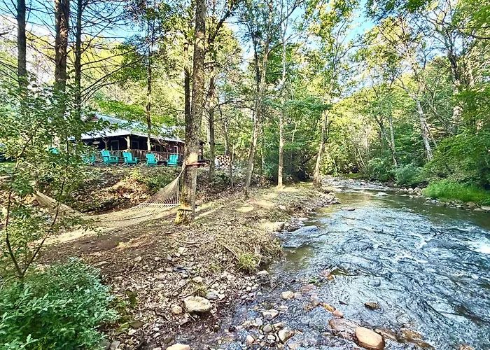 Cabin On Mountain Stream, Surrounded By Forest